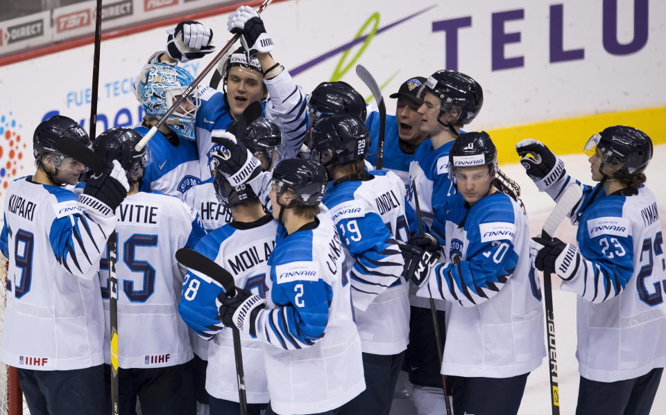 Finland celebrates a win over Switzerland in a world junior hockey championships semifinal in Vancouver, British Columbia, Friday, Jan. 4, 2019. (Jonathan Hayward/The Canadian Press via AP)