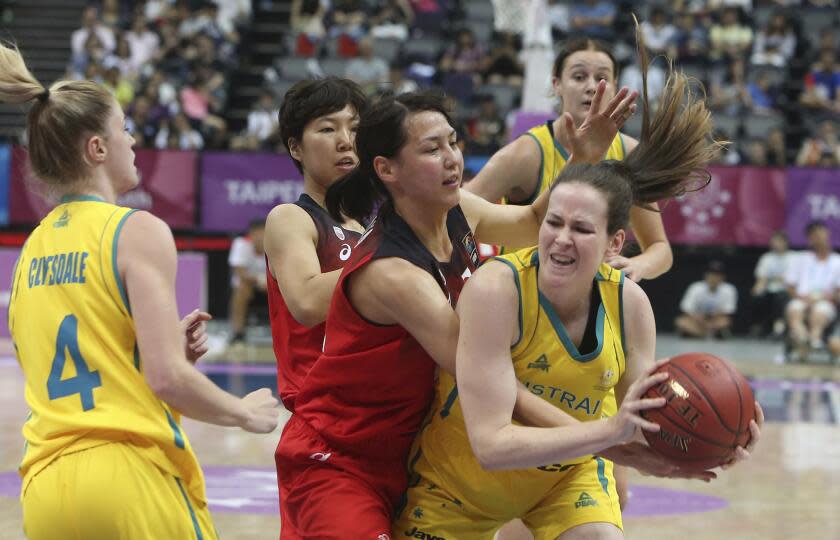 Australia''s Keely Jane Froling (11), right, and Japan''s Mamiko Tanaka (12) fight for a loose ball