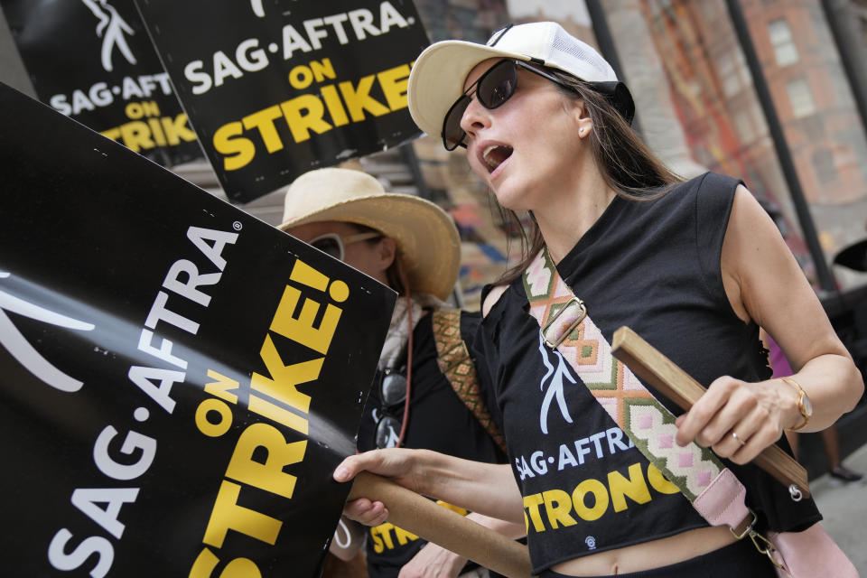 Striking writers and actors chant as they walk a picket line, Monday, July 17, 2023, in New York. Three years after the pandemic brought Hollywood to a standstill, the film and TV industry has again ground to a halt. This time, though, the industry is engaged in a bitter battle over the how streaming — after advancing rapidly during the pandemic — has upended the economics of entertainment. (AP Photo/John Minchillo)