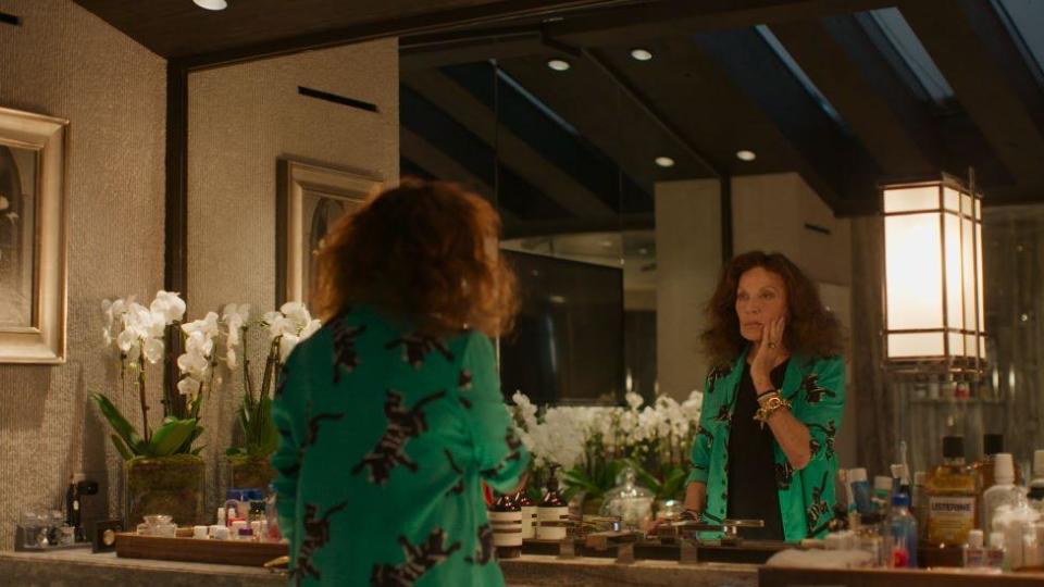 Diane von Furstenberg looking in a mirror