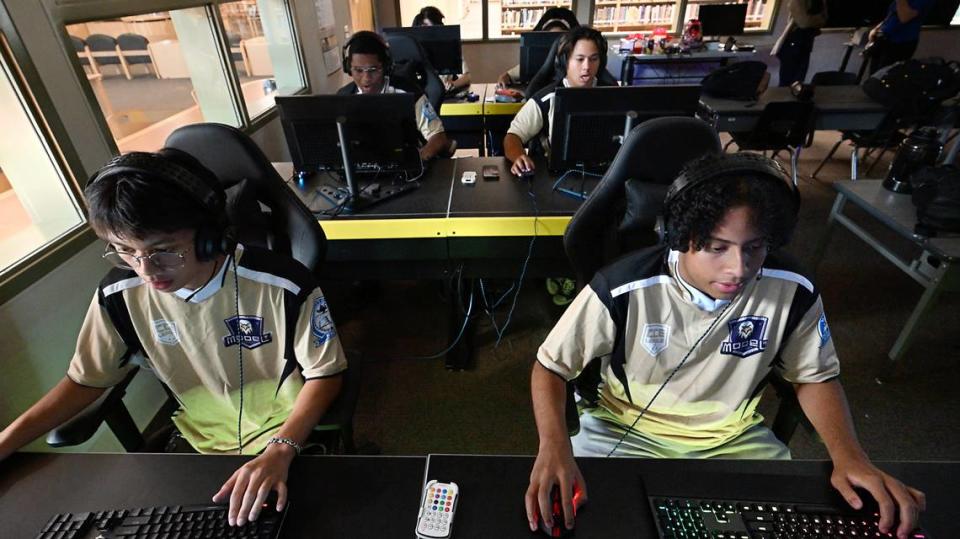 Enochs esport players Kenshin Covero, left, Nicholas Peraza, right, and their teammates play an Overwatch match against Tracy High School at Enochs High School in Modesto, Calif., Tuesday, Sept. 19, 2023.