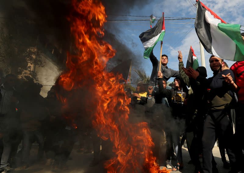 Palestinians protest as tires burn ahead of the announcement by U.S. President Donald Trump of his long-delayed Mideast peace plan, in Gaza City