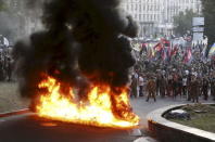 Tyres are set on fire during a rally held by members of the far-right radical group Right Sector, representatives of the Ukrainian volunteer corps and their supporters in central Kiev, Ukraine, in this July 3, 2015 file photo. REUTERS/Valentyn Ogirenko/Files