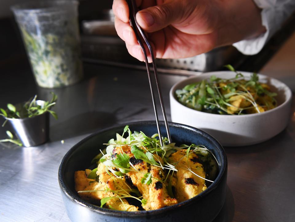 Diego Campos is a Chef de Cuisine at CAMP in the Camperdown Plaza in downtown Greenville. Here, he makes a dish of Chicken Tikka with local cucumber and celery salad at the restaurant on Thursday, July 27, 2023.