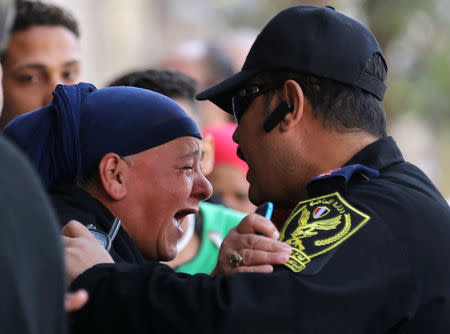 A relative of one of the blast victims screams at a police officer in front of St. Mark's Coptic Orthodox Cathedral after an explosion inside the cathedral in Cairo, Egypt December 11, 2016. REUTERS/Mohamed Abd El Ghany