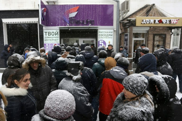 People queue outside the local mobile operator "Phoenix" despite the snow in Donetsk