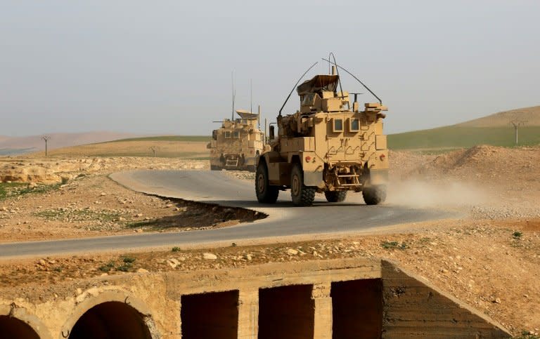 US-made armoured vehicles bearing markings of the US Marine Corps on a road north of Raqa in northern Syria as clashes region in the area between US-backed forces and Islamic State group jihadists