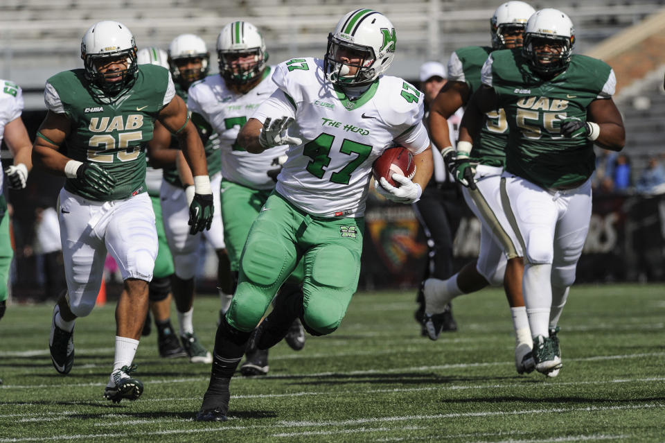 Marshall running back Devon Johnson (47) was one of the nation’s leading rushers in 2014. (AP Photo/John Amis)