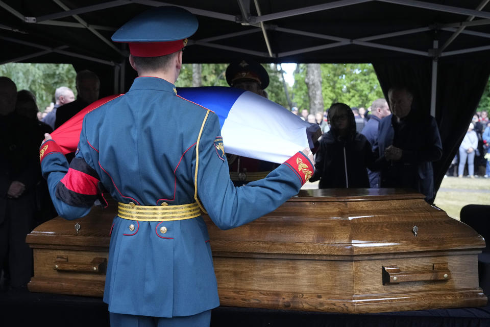 Honor guards remove a Russian flag from the coffin of former Soviet President Mikhail Gorbachev during his funeral at Novodevichy Cemetery in Moscow, Russia, Saturday, Sept. 3, 2022. (AP Photo/Alexander Zemlianichenko, Pool)