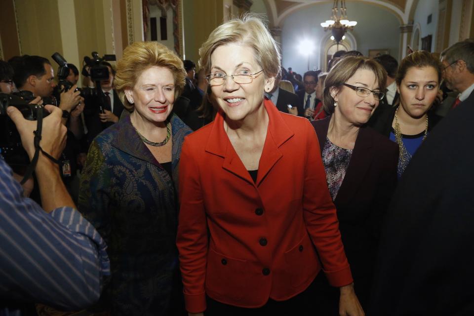 U.S. Senator Elizabeth Warren (D-MA) (C), flanked by Senator Debbie Stabenow (D-MI) (L) and Senator Amy Klobuchar (D-MN) (R), leaves after speaking to reporters following a leadership election for the 114th Congress on Capitol Hill in Washington in a November 13, 2014 file photo. Backed with $1.25 million from liberal advocacy groups MoveOn.org and Democracy for America, the "Run Warren Run" group has opened offices in New Hampshire and Iowa, hoping she will jump in and contending Warren's message of populist economics could propel her into the White House in 2016. REUTERS/Jonathan Ernst/files (UNITED STATES - Tags: POLITICS)