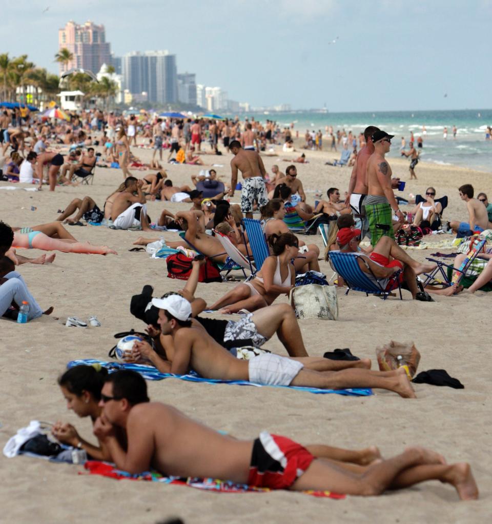 Students and locals share the beach in Fort Lauderdale Beach during spring break.