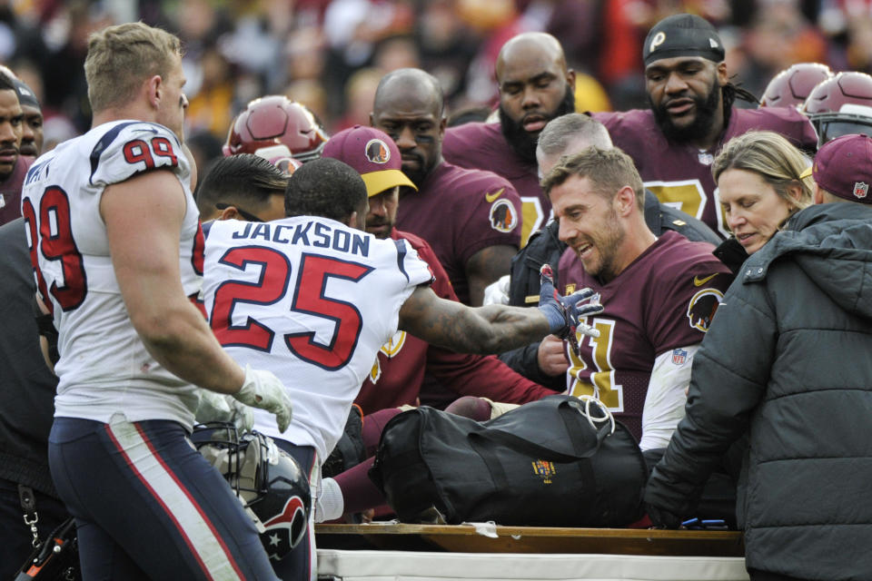 Houston Texans strong safety Kareem Jackson (25) reaches for Washington Redskins quarterback Alex Smith (11) as he leaves the field after an injury during the second half of an NFL football game, Sunday, Nov. 18, 2018 in Landover, Md. (AP Photo/Mark Tenally)