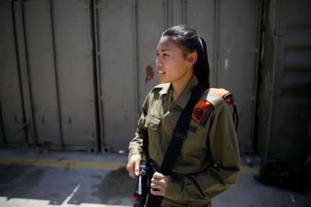 Joana Chris Arpon, an Israeli soldier from a search and rescue unit, whose parents immigrated from the Philippines, looks on during a drill at Tzrifin military base in central Israel May 10, 2017. REUTERS/Amir Cohen
