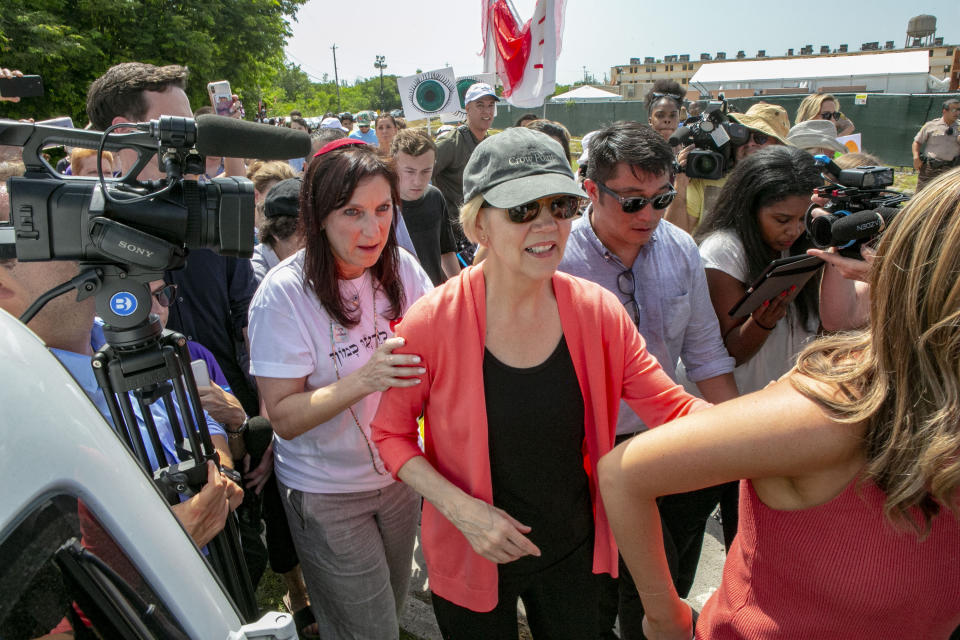 Democratic presidential candidate Sen. Elizabeth Warren, D-Mass., is swarmed by the media while walking past the Homestead Detention Center, where the U.S. is detaining migrant teens, in Homestead, Fla., Wednesday June 26, 2019. (Daniel A. Varela/Miami Herald via AP)