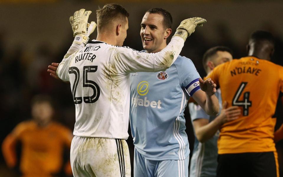 Robbin Ruiter and team-mate John O'Shea celebrate on the whistle after Sunderland claimed a point  - PA