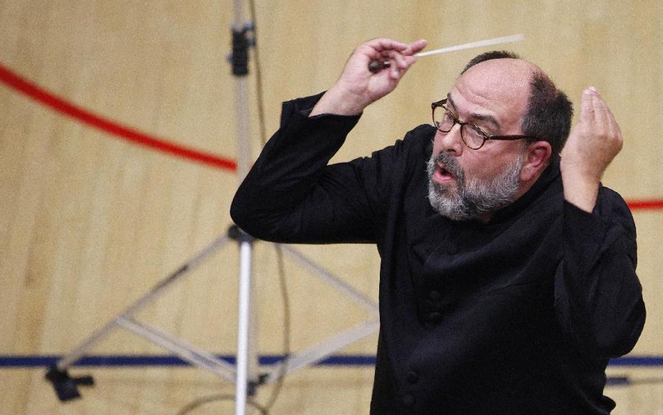 In this photo taken Monday, Sept. 24, 2012, Kenneth Freed conducts the Musicians of the Minnesota Orchestra during the ACME Concert, a free event in the gymnasium at the North Community YMCA, in Minneapolis. The Minnesota Orchestra was called the world's greatest not long ago, welcome recognition for musicians outside a top cultural center. Now its members are locked out of Orchestra Hall, stuck in the same kind of labor-management battle recently afflicting teachers and football referees. (AP Photo/Stacy Bengs)