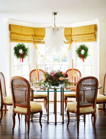 <p>Brie Williams</p> Use tall tapers to add height to the tablescape without blocking the view.