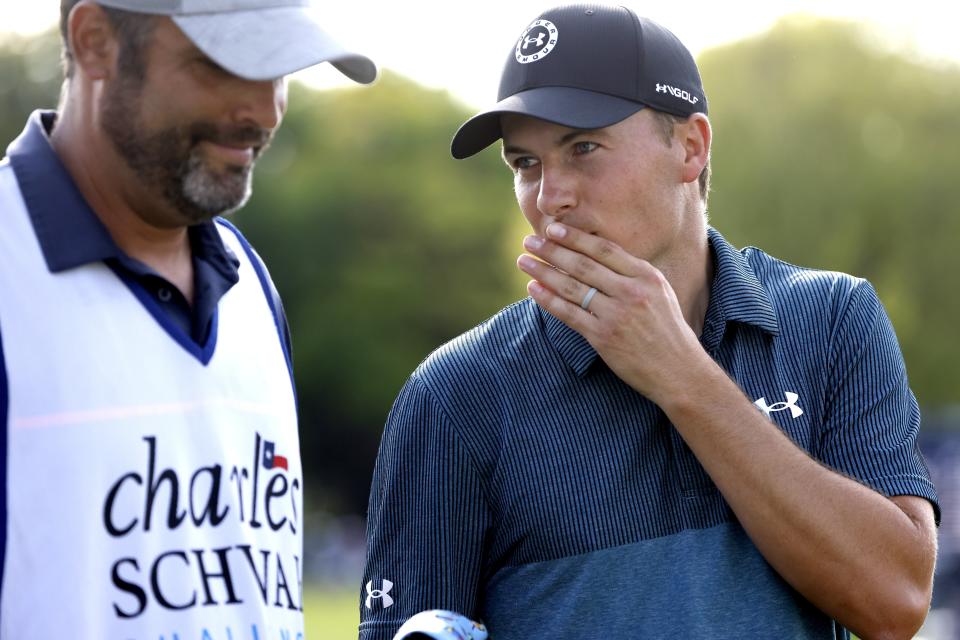 Jodan Spieth, right, talks with his caddie after playing through the 18th green during the third round of the Charles Schwab Challenge golf tournament at the Colonial Country Club in Fort Worth, Texas, Saturday May 29, 2021. (AP Photo/Ron Jenkins)