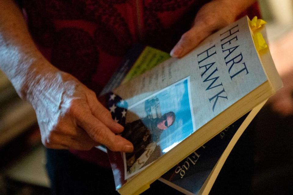 Deborah Tainsh, an author and gold star mother, shows off her first book Heart of a Hawk at home in Biloxi on Wednesday, Nov. 8, 2023. The death of her step-son Patrick, who died fighting in Iraq, inspired her to write.