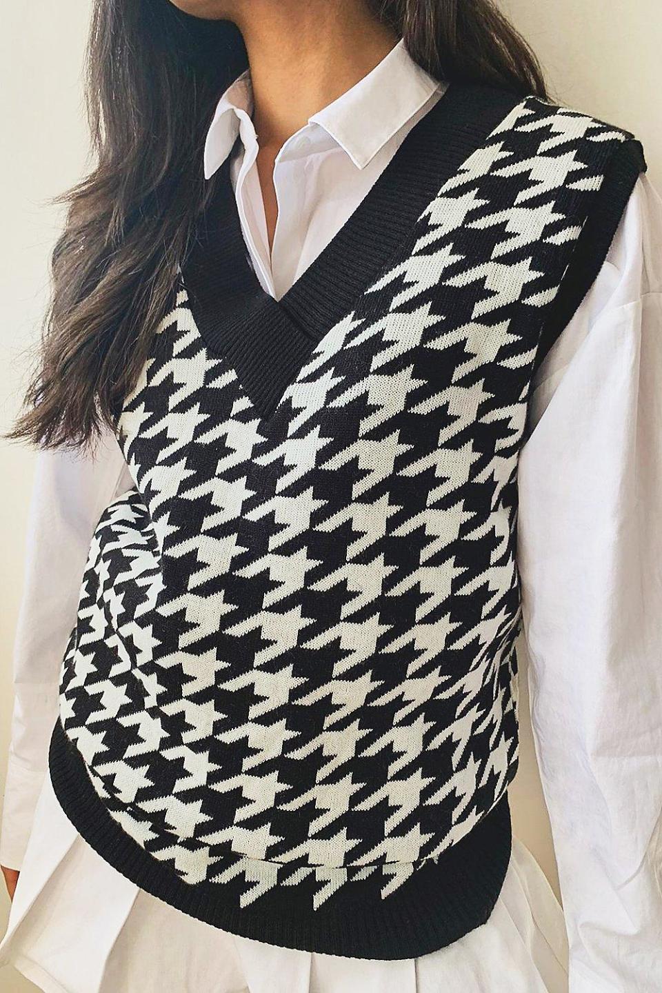 Model wears Dogtooth Check Sweater Vest in black/white