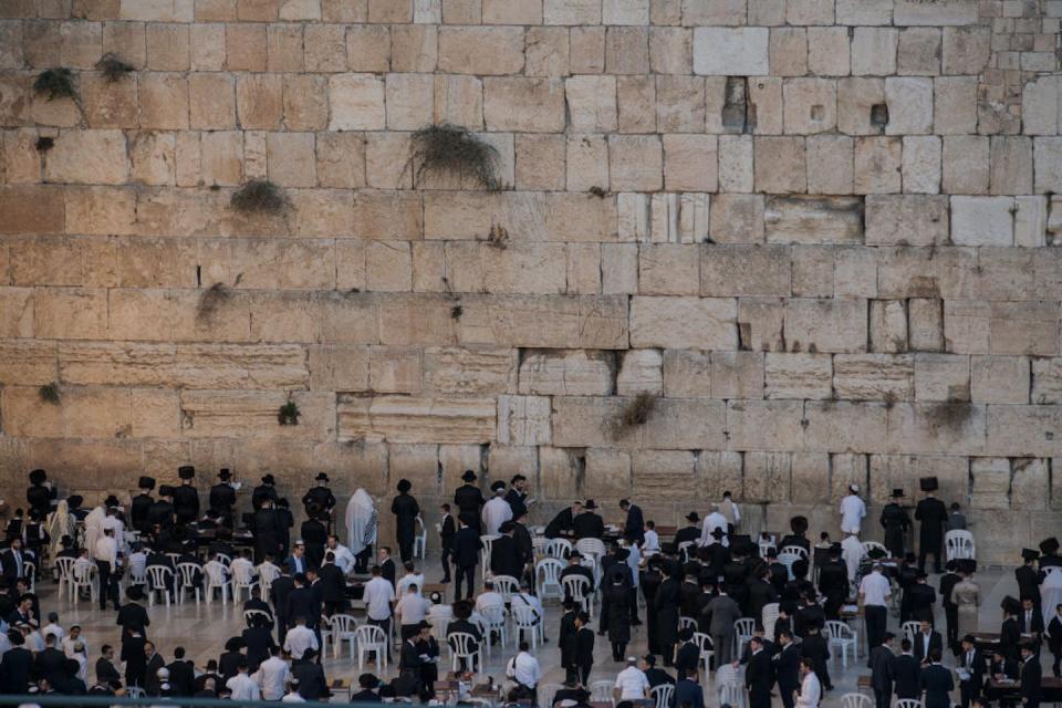 Jewish men pray at the Western Wall in Jerusalem, part of Herod’s expansion of the temple complex. <a href="https://www.gettyimages.com/detail/news-photo/members-of-the-jewish-community-gather-to-pray-at-the-news-photo/1779946594?adppopup=true" rel="nofollow noopener" target="_blank" data-ylk="slk:Israel Fuguemann/SOPA Images/LightRocket via Getty Images;elm:context_link;itc:0;sec:content-canvas" class="link ">Israel Fuguemann/SOPA Images/LightRocket via Getty Images</a>