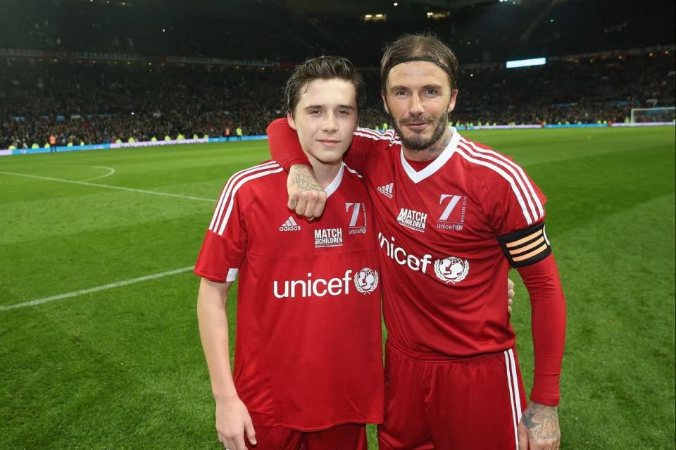 David Beckham of Great Britain and Ireland poses with his son Brooklyn Beckham after the David Beckham Match for Children in aid of UNICEF between Great Britain and Ireland and the Rest of the World at Old Trafford in 2015 (Photo by John Peters/Manchester United via Getty Images) (Manchester United via Getty Images)