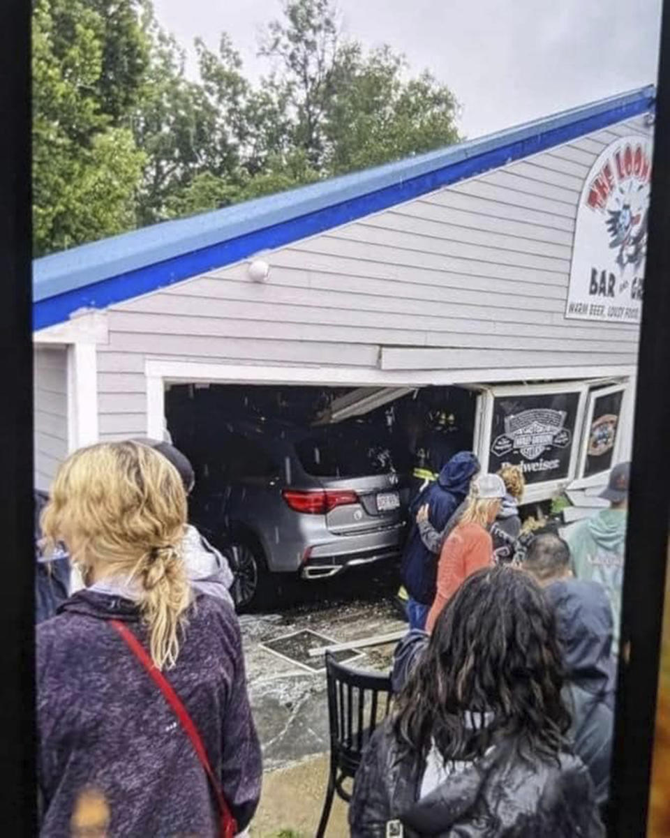 In this photo released by the Laconia Fire Department, a vehicle sits inside a restaurant after crashing through the wall on Sunday, July 2, 2023, in Laconia, NH. The car struck the busy Looney Bin Bar & Grill and injured more than a dozen patrons inside, authorities said. (Laconia Fire Department via AP)