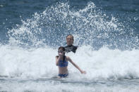 People play in the water in the heat at Santa Monica Beach on Wednesday, June 16, 2021, in Santa Monica, Calif. (AP Photo/Ringo H.W. Chiu)