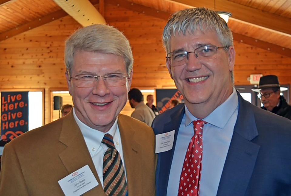 Community Foundation of Central Missouri Executive Director John Baker officially passed the torched Wednesday to his successor Eric Sappington during Baker's retirement celebration at the Reichmann Indoor Pavilion at Stephens Lake Park.