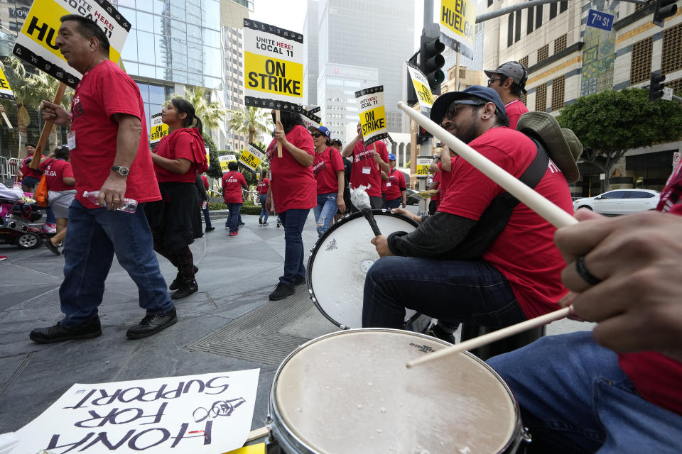 Striking hotel workers play drums as they rally outside the Intercontinental Hotel on Monday, July 3, 2023, in downtown Los Angeles. (AP Photo/Damian Dovarganes)