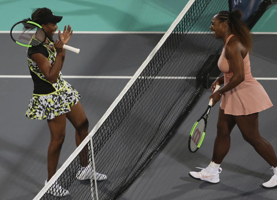 Venus Williams, left, from the U.S., celebrates after defeating her sister, Serena, in a match during the opening day of the Mubadala World Tennis Championship in Abu Dhabi, United Arab Emirates, Thursday, Dec. 27, 2018. (AP Photo/Kamran Jebreili)