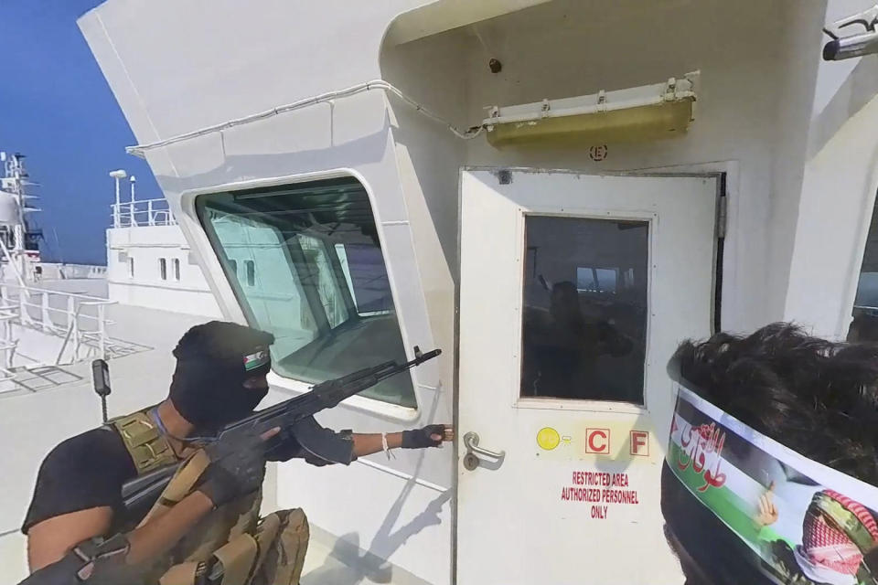 A photo released by the Houthi Media Center shows Houthi forces boarding the cargo ship Galaxy Leader in the Red Sea on Nov. 19, 2023.  (Houthi Media Center via AP)