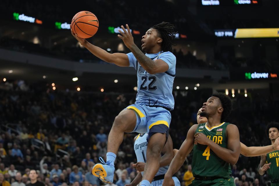 Marquette's Sean Jones shoots past Baylor's LJ Cryer during the first half of an NCAA basketball game Tuesday, Nov. 29, 2022, in Milwaukee. (AP Photo/Morry Gash)