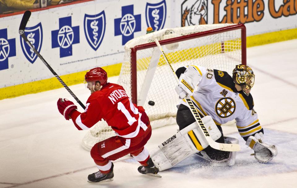 Detroit Red Wings forward Gustav Nyquist (14) scores the game-winning goal against Boston Bruins goalie Tuukka Rask (40), of Finland, during the third period of an NHL hockey game in Detroit, Mich., Wednesday, April 2, 2014. The Red Wings won 3-2. (AP Photo/Tony Ding)