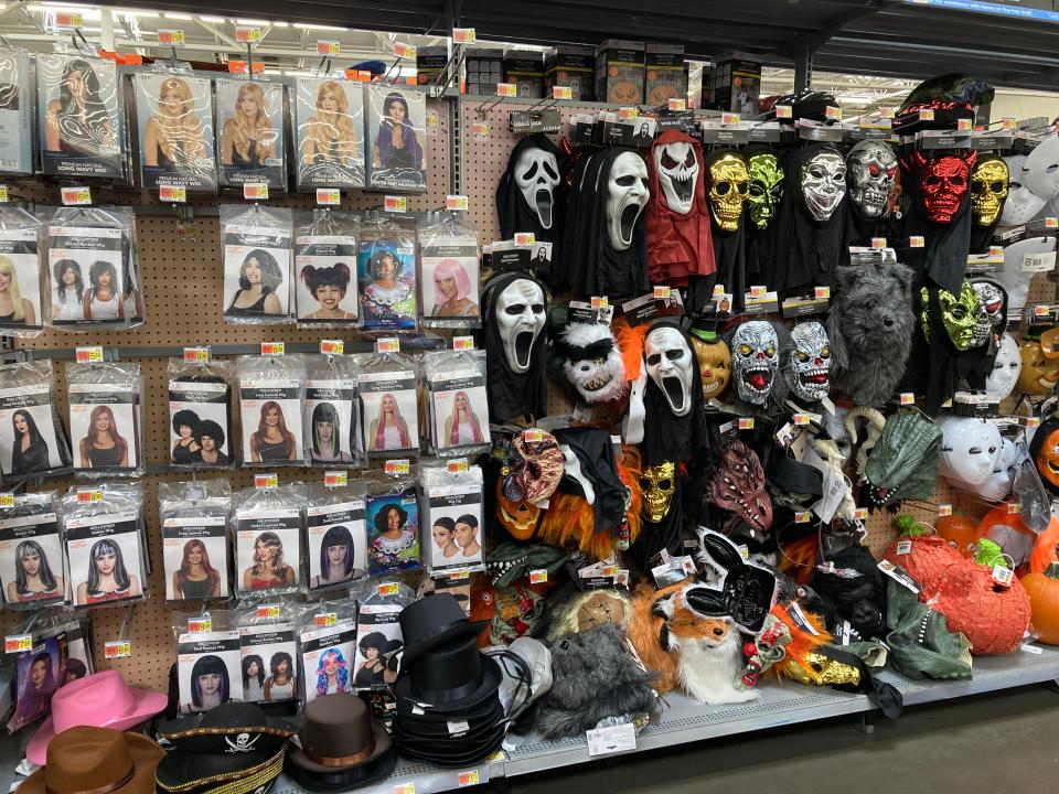 Halloween costumes including wigs and masks for sale at Walmart.