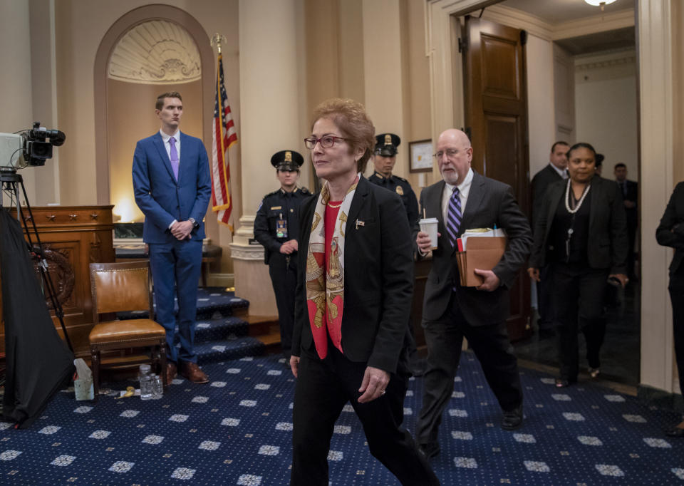 Former U.S. Ambassador to Ukraine Marie Yovanovitch, accompanied by her attorney Lawrence Robbins, right, returns from a break to testify before the House Intelligence Committee, Friday, Nov. 15, 2019, on Capitol Hill in Washington, in the second public impeachment hearing on President Donald Trump's efforts to tie U.S. aid for Ukraine to investigations of his political opponents. (AP Photo/J. Scott Applewhite)