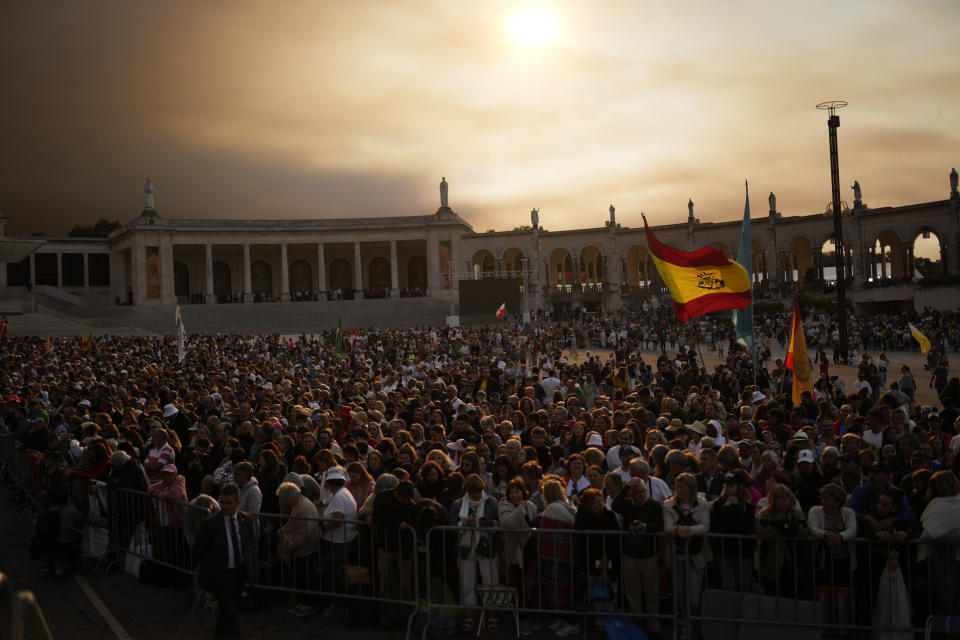 A Spanish flag is waved as a worshipers wait to the arrival of Pope Francis at Our Lady of Fatima shrine in Fatima, central Portugal Saturday, Aug. 5, 2023. Pope Francis is in Portugal through the weekend into Sunday's 37th World Youth Day to preside over the jamboree that St. John Paul II launched in the 1980s to encourage young Catholics in their faith. (AP Photo/Francisco Seco)