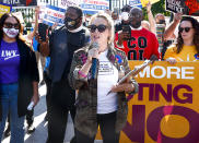 <p>Alyssa Milano takes the mic at the "No More Excuses: Voting Rights Now" rally on Oct. 19 held in front of The White House in Washington, D.C.</p>