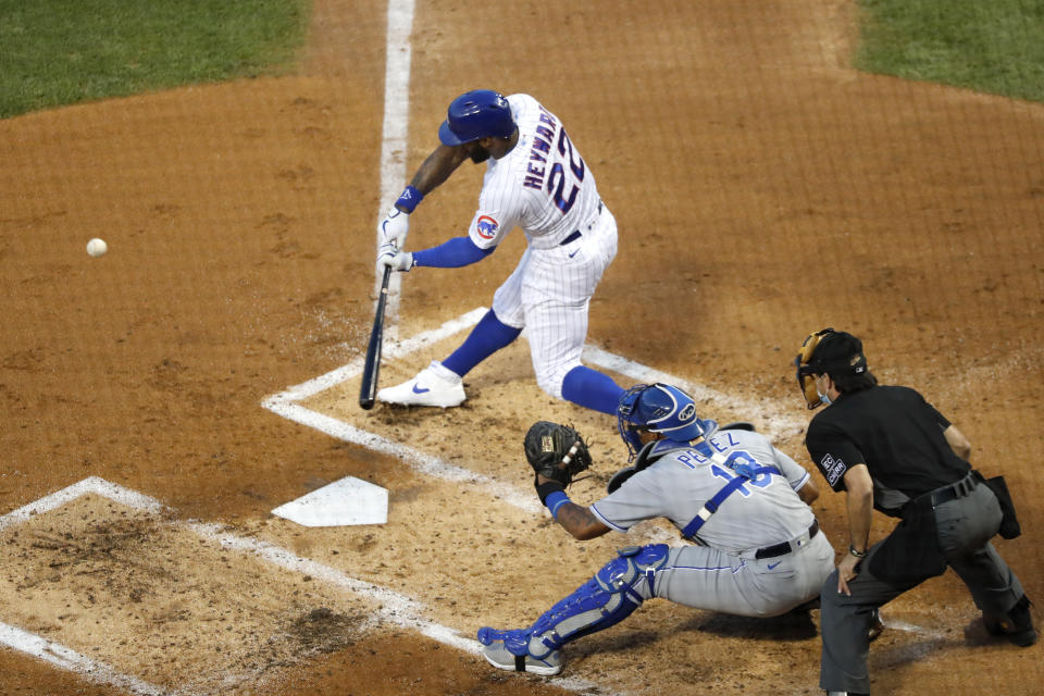 Chicago Cubs' Jason Heyward (22) swings into a two-run home run off Kansas City Royals starting pitcher Brady Singer, during the second inning of a baseball game Tuesday, Aug. 4, 2020, in Chicago. (AP Photo/Charles Rex Arbogast)