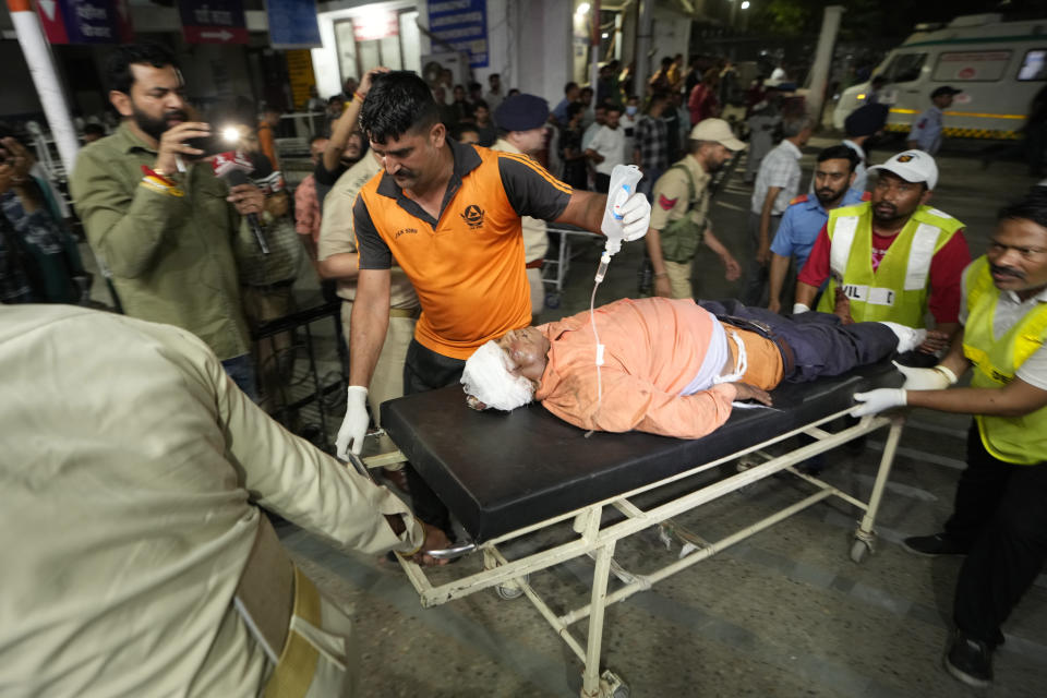 An injured man is brought to the Government Medical College Hospital in Jammu after the bus he was traveling in fell into a deep gorge in the Pouni area of Jammu's Reasi district, India, Sunday, June 9, 2024. Officials in Indian-controlled Kashmir say at least nine people have been killed after suspected militants fired at a bus with Hindu pilgrims, which then fell into a deep gorge. (AP Photo/Channi Anand)