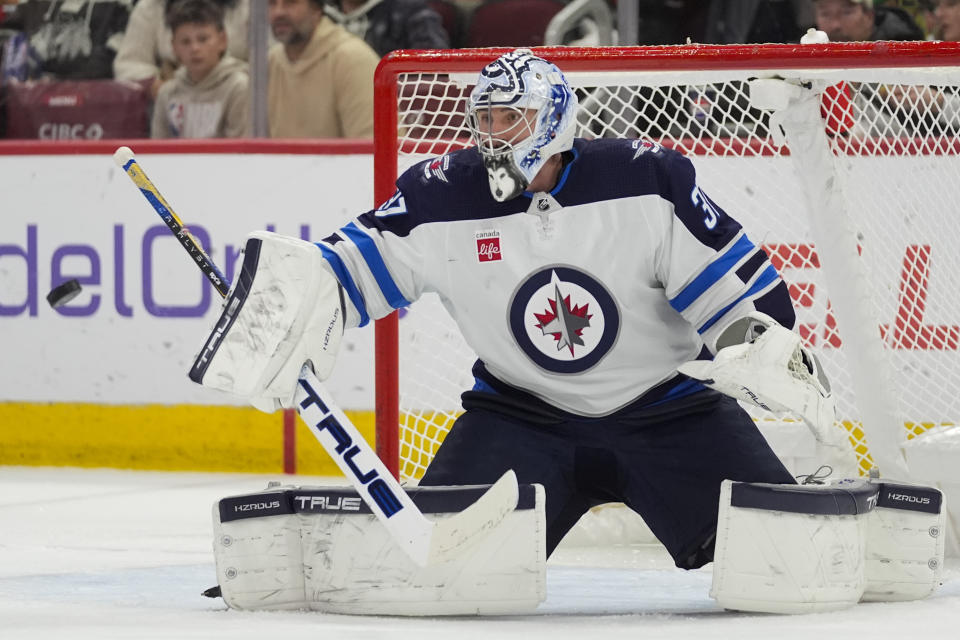 Winnipeg Jets goaltender Connor Hellebuyck makes a save during the second period of an NHL hockey game against the Chicago Blackhawks, Friday, Feb. 23, 2024, in Chicago. (AP Photo/Erin Hooley)