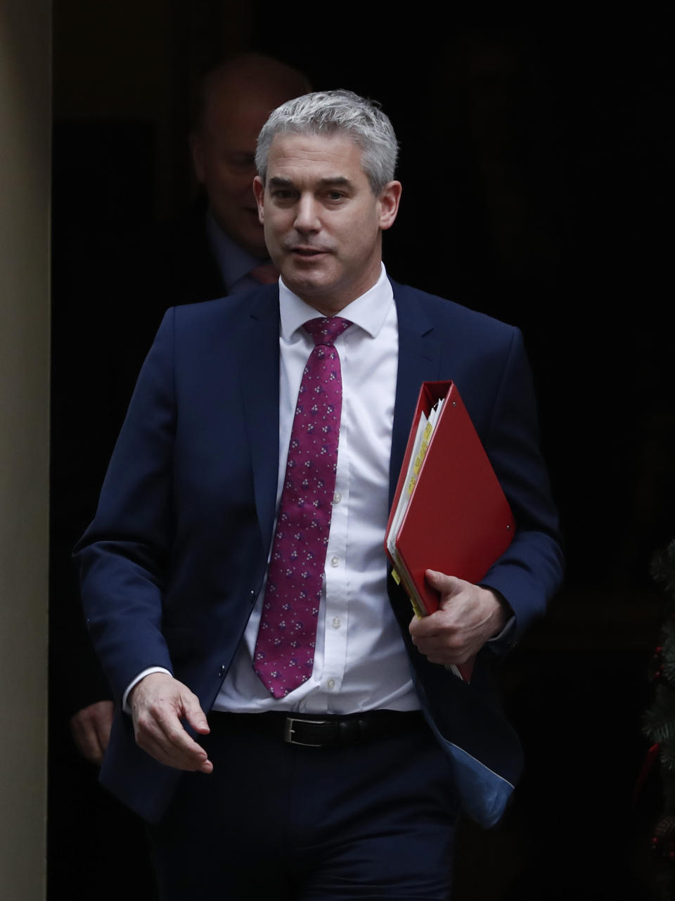 Stephen Barclay the Secretary of State for leaving the EU, walks out of 10 Downing Street, following a cabinet meeting in London Tuesday, Dec. 18, 2018. (AP Photo/Alastair Grant)