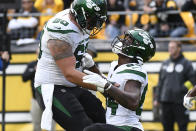 New York Jets wide receiver Corey Davis celebrates with center Connor McGovern after catching a touchdown pass against the Pittsburgh Steelers during the second half of an NFL football game, Sunday, Oct. 2, 2022, in Pittsburgh. (AP Photo/Don Wright)