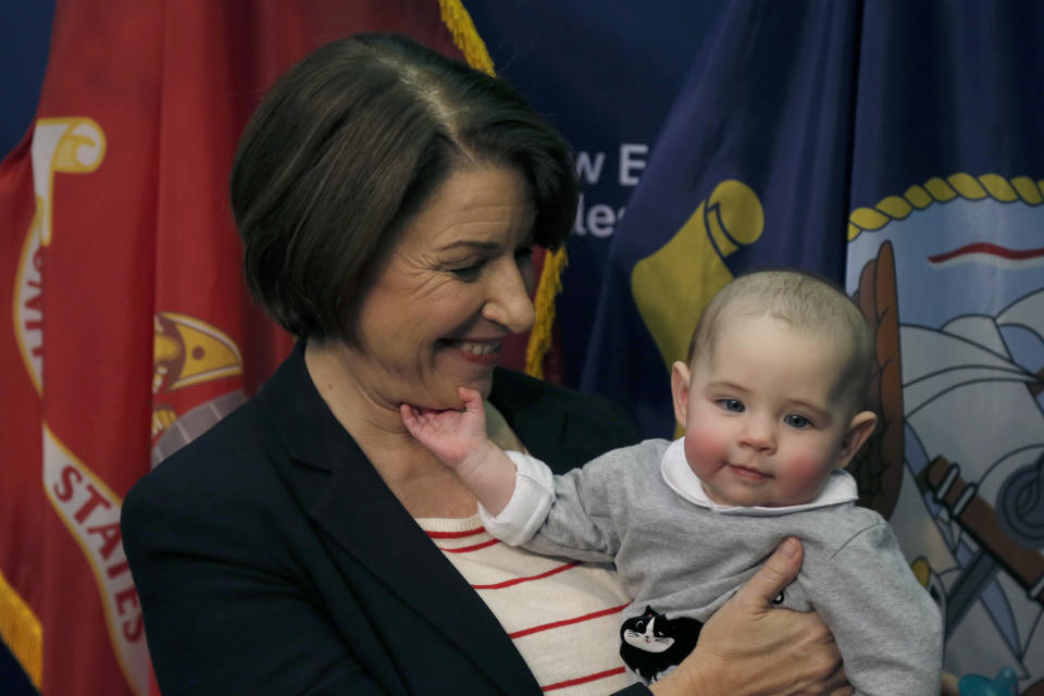 Democratic presidential candidate Sen. Amy Klobuchar, D-Minn., holds a baby named Eleanor as she takes photos during a campaign stop, Friday, Nov. 22, 2019, in Henniker, N.H. (AP Photo/Mary Schwalm)