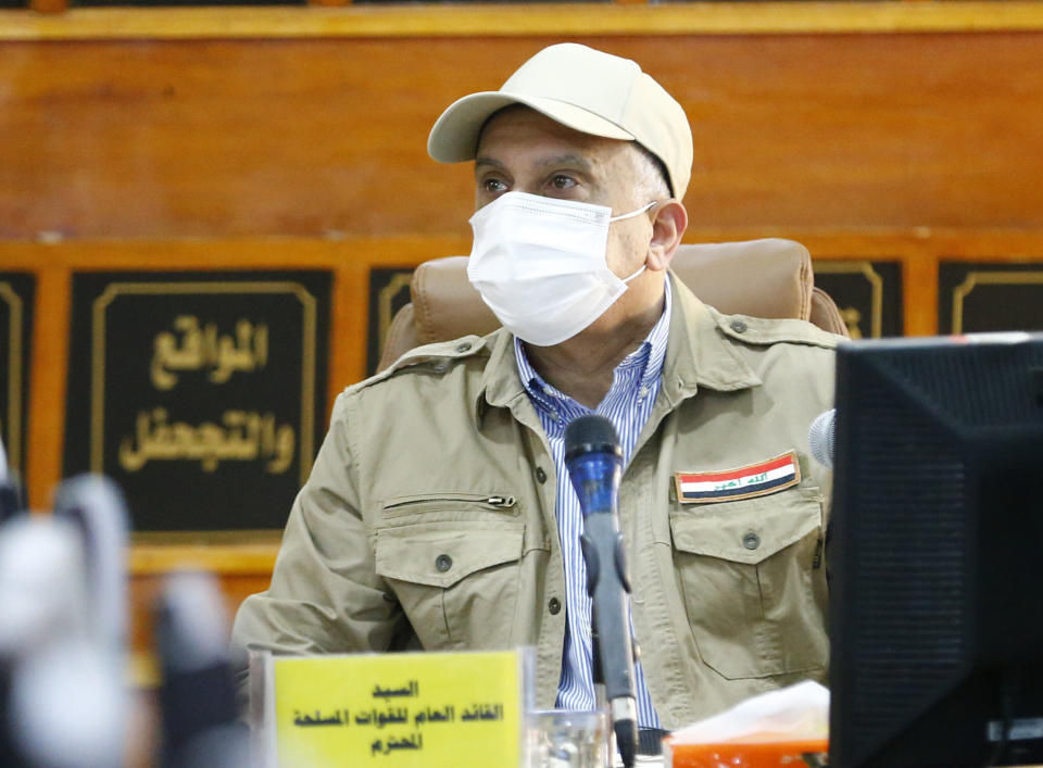 Iraqi Prime Minister Mustafa al-Kadhimi speaks to the journalists at Iraq-Iran border crossing of Mandali in northern province of Diyala, Iraq, Saturday, July, 11, 2020. Al-Kadhimi launched a campaign in the northern province of Diyala to enforce the proper payment of taxes on imported goods and recover "hundreds of millions of dollars" in revenues lost to bribery and other illicit practices. Security forces from the Interior Ministry would supervise the work of border guards in the first step of the campaign in the Mandili border crossing, he told reporters. (Thaier al-Sudani, Pool via AP)