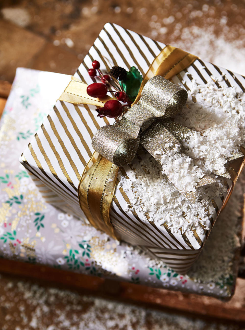 <p>Wrap up gifts with shimmering papers in simple designs such as stripes and stars; dress them up with metallic, wired ribbons and pre-made bows and bunches of faux berries or hips to make them extra special. </p><p>For an added festive touch, you could clip on decorations that are usually reserved for the tree, such as bells, baubles and birds.</p><p><strong>MORE: </strong><a rel="nofollow noopener" href="http://www.countryliving.co.uk/create/craft/how-to/a956/country-inspired-christmas-gift-wrapping-ideas/" target="_blank" data-ylk="slk:15 country-inspired Christmas gift wrapping ideas;elm:context_link;itc:0;sec:content-canvas" class="link "><strong>15 country-inspired Christmas gift wrapping ideas</strong></a></p>