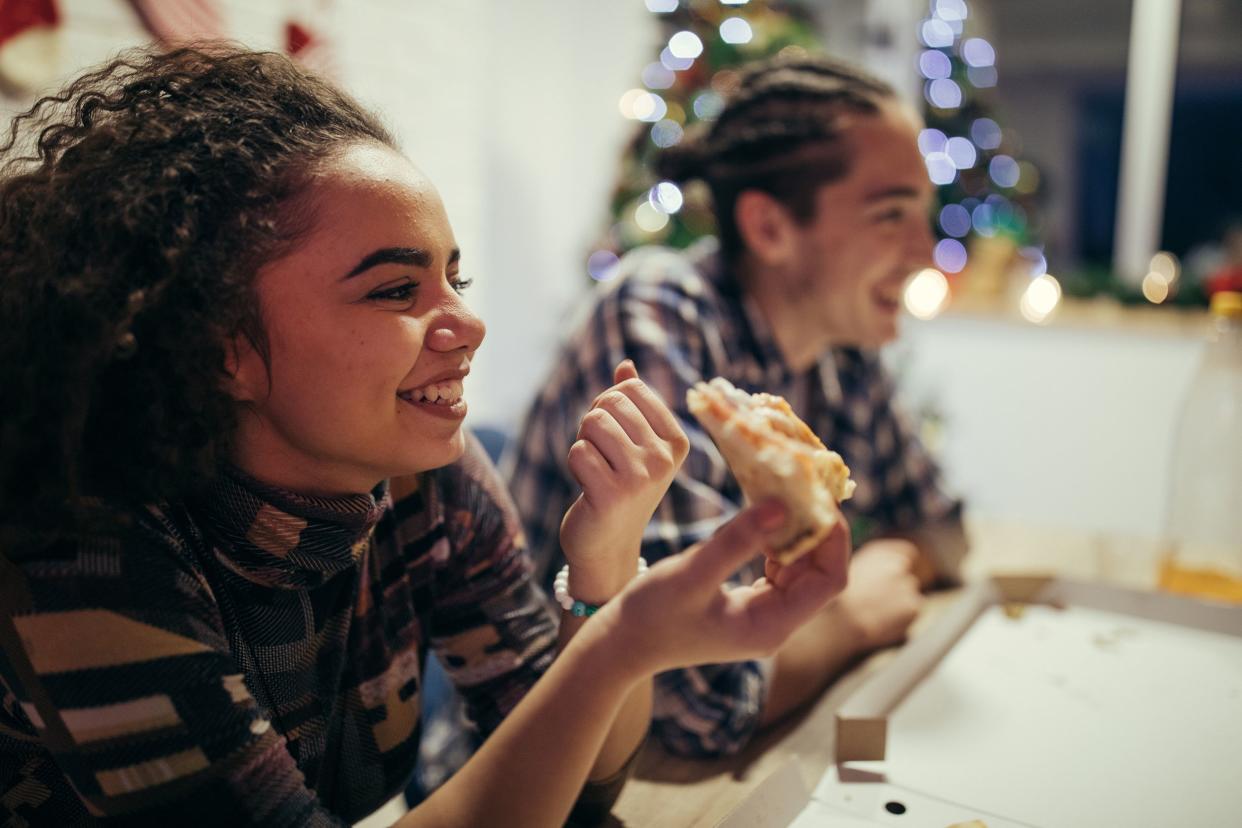 couple eating pizza on Christmas eve