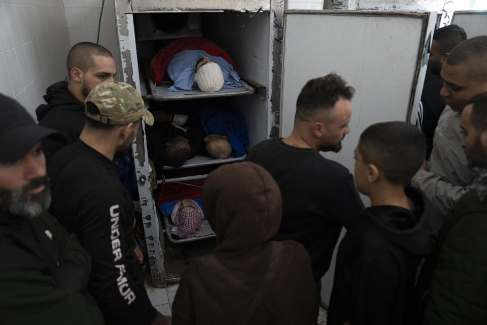 Mourners take the last look at the bodies of killed Palestinians ahead of their mass funeral in the West Bank city of Tulkarem, Friday, Jan. 19, 2024. The Israeli army withdrew early morning from the Tulkarem refugee camp after a 45 hours wide military operation in the refugee camp, the Israeli army said. Eight Palestinians were killed by the Israeli army during the Israeli army operation in the refugee camp, the Palestinian health ministry said. (AP Photo/Nasser Nasser)