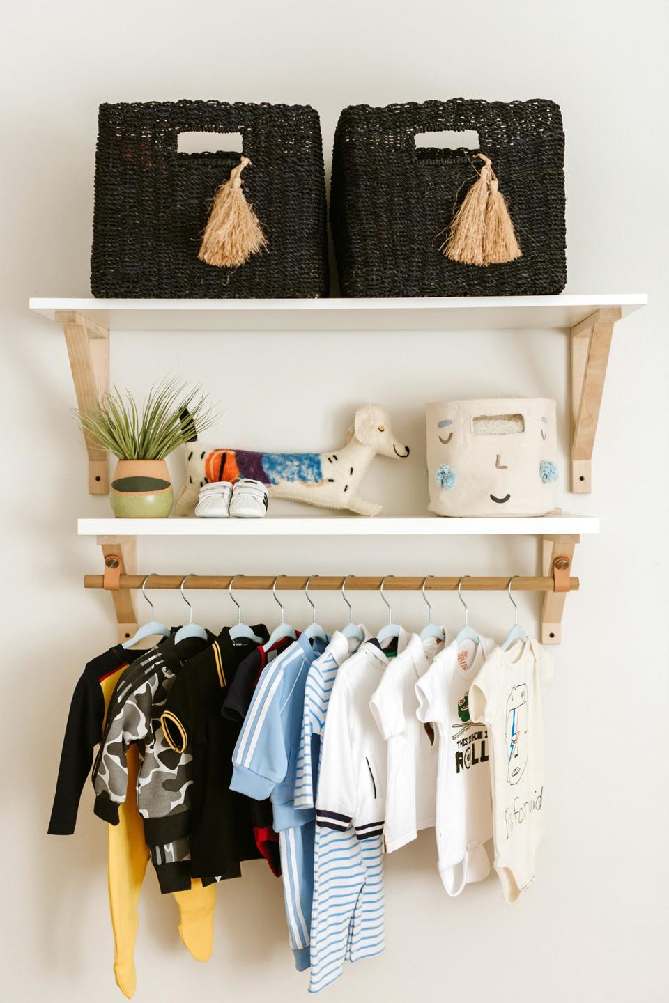 This may be my favorite DIY moment, even though I didn’t actually do it myself. I wanted to create a space to hang some of Sonny’s special pieces! I mean, how cute are baby clothes? Also, I’m in love with my baskets from <a href="https://www.pntrs.com/t/8-4759-131940-50885?sid=PEO%2CInsideActressCamilleGuaty%27sDreamyNurseryforHerNewbornSonMorrisonRafael%2Cmchiupeople%2CUnc%2CGal%2C7425263%2C201911%2CI&url=https%3A%2F%2Fwww.serenaandlily.com%2F" rel="nofollow noopener" target="_blank" data-ylk="slk:Serena and Lily;elm:context_link;itc:0;sec:content-canvas" class="link ">Serena and Lily</a>.