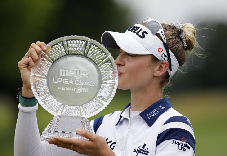 Nelly Korda kisses the trophy after winning the Meijer LPA Classic golf tournament, Sunday, June 20, 2021, in Grand Rapids, Mich. (AP Photo/Al Goldis)